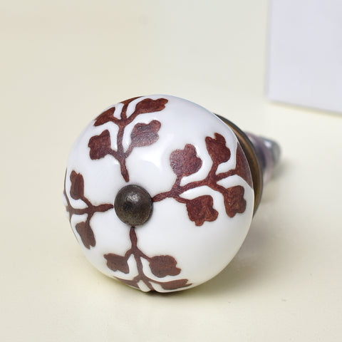 White ceramic knob with brown leaf design